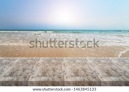 Similar – two straw beach umbrellas on an empty seashore on a clear day