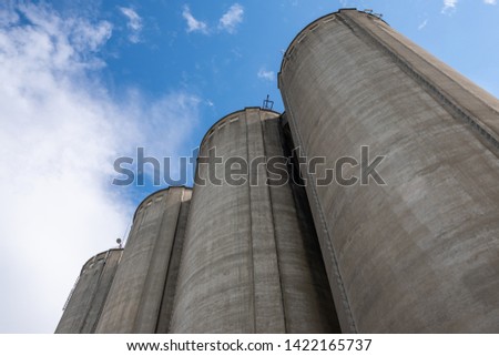 Cement silo towers, represents data silos in computer science, which isolate data since the only access gate to the data is a single application