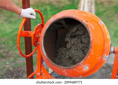 Cement Slurry In An Orange Concrete Mixer On A Sunny Summer Day