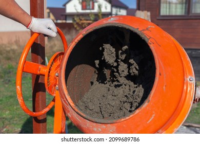 Cement Slurry In An Orange Concrete Mixer On A Sunny Summer Day