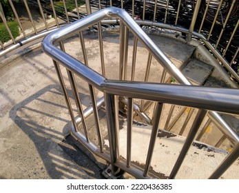 Cement spiral staircase with aluminum handrails
				
				