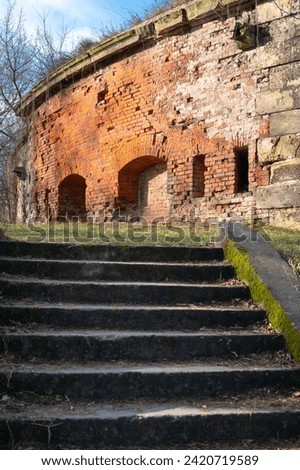 Cement stairs lead to a post-military building, once a tsarist military fortress
