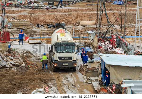Cement truck, Concrete mixer truck for construction,\
tube mixer cement truck. Concrete pouring. pumping in flexible\
hoses fed. transit mix trucks. building under construction,\
scaffolding. Moscow 2019