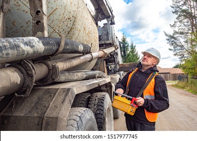 Cement Truck. A Man Controls The Flow Of Concrete. Delivery Of Concrete To The Construction Site. Remote Control Cement Supply. Building.