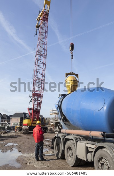 cement\
truck unloading on construction site and blue\
sky