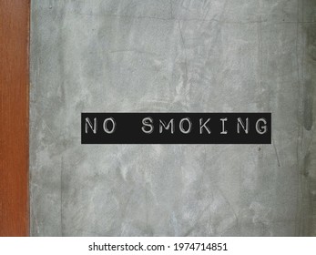 Cement wall with sign NO SMOKING , to inform this public area, workplace, spaces, is protected from tobacco smoke, smoking is prohibited for health and safety regulations - Shutterstock ID 1974714851