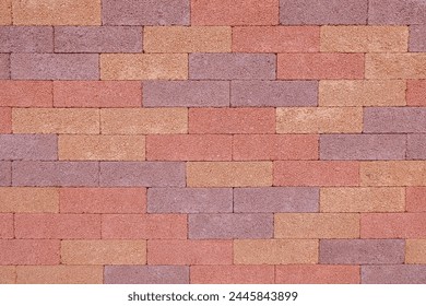 Cement wall texture and pattern. Neatly installed cement wall. Dominant red color. Forming abstract patterns and textures