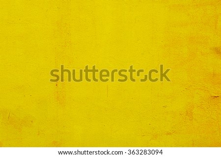 cement yellow wall with street, textured background