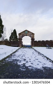 Cemetary Gate In Winter With A Peaceful Atmosphere. Overcast Sky, On The Footpath Entry.