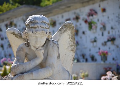 Cemetery angel mourning for soul - All Souls' Day (with a blurred cemetery background - copy space)