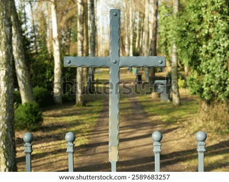 The cemetery gate with a metal cross symbolizes mourning, remembrance, and peace. A silent place of reflection, marked by dignity, spirituality, and eternity.