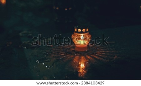 Cemetery Grave Tombstone Decorated with Candle Lanterns on All Saints Day Evening