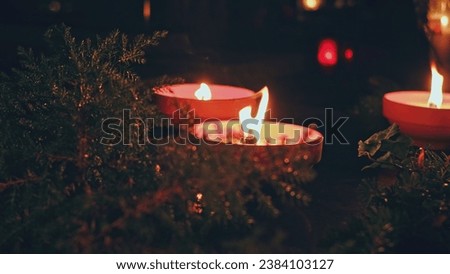 Cemetery Grave Tombstone Decorated with Clay Candles on All Saints Day Evening