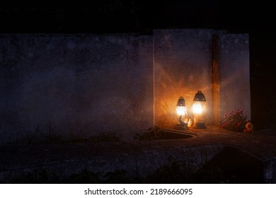 cemetery lamps light on tomb stone concrete surface at night time beautiful Halloween eve aesthetic October atmosphere, copy space 