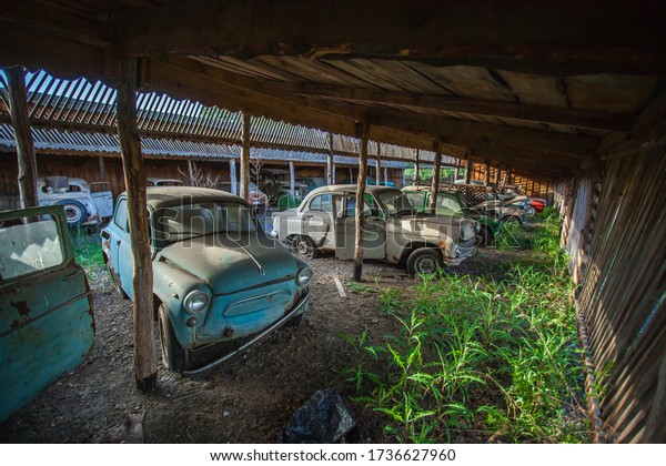 cemetery of old abandoned Soviet cars. in an\
abandoned Parking lot