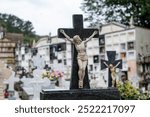 Cemetery with old unkempt graves. Stone tombstones, metal crosses. City cemetery. Gravestones and stone crosses, abandoned and overgrown with grass graves of unknown people. The concept of death, the 