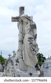 Cemetery Statue Of A Woman Hugging The Cross