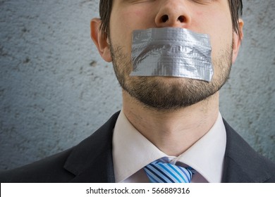 Censorship Concept. Man Is Silenced With Adhesive Tape On His Mouth.