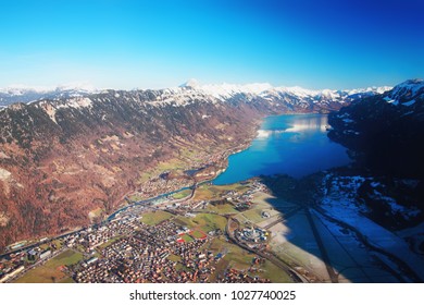 The Center Of Bernese Apline City Of Interlaken At Winter Swiss Alps, Helicopter View. Brienz Lake On The Background