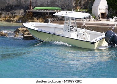 Center Console Fishing Boat Moored To Dock And Rocking In Waves, Bermuda