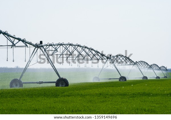 Center Pivot\
Irrigation System in a green\
Field