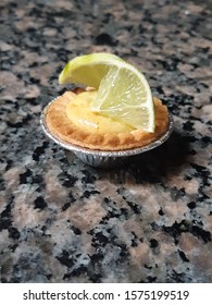 A Centered Mini Key Lime Pie With A Slice Of Lime On Top