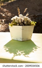 Centerpiece With Wild Flowers And Wooden Planter