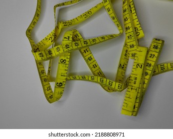 Centimeter tape. Tailor's meter, for sewing, on a grey background. Meter, tape measure, to measure the body, waist in centimeters. flat lay.