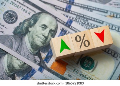 The central banking system of the United States and changing interest rates. Percentage symbol and arrow symbol on the wooden cube.
