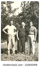 Central Bulgaria, BULGARIA, CIRCA 1955 - three men in the garden - circa 1955