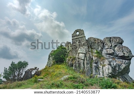 Central Cornwall tourist site on a summer day,a granite outcrop with ancient ruined chapel and tower.A former Hermitage,near Bodmin and St.Austell, protruding from surrounding green countryside,