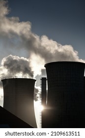 Central heating system. Smoke is getting out of cooling chimney of a thermal power plant. Pollution inside a city, danger for the environment.