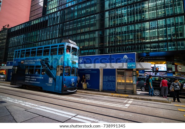 CENTRAL, HONG KONG -\
SEPTEMBER 22, 2017 : Double deck tram on busy street of Central\
Hong Kong. Trams is major tourist attraction and famous\
transportation system in\
HK
