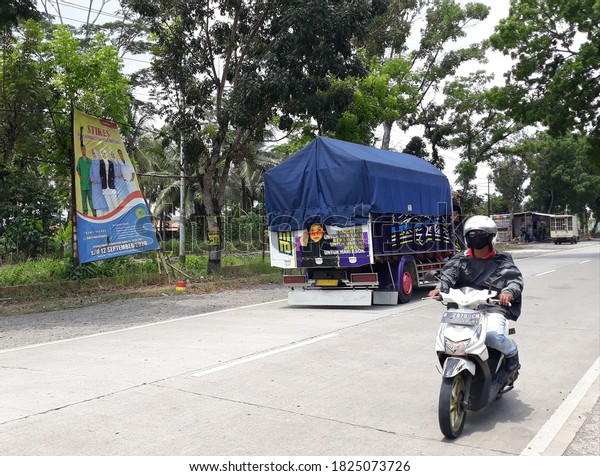 Central\
Java, 01 October 2020, trucks cross the\
road