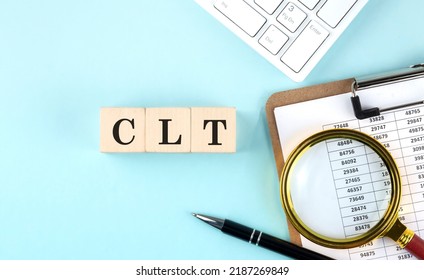 Central Limit Theorem -CLT Word On A Wooden Cubes On Blue Background With Chart And Keyboard