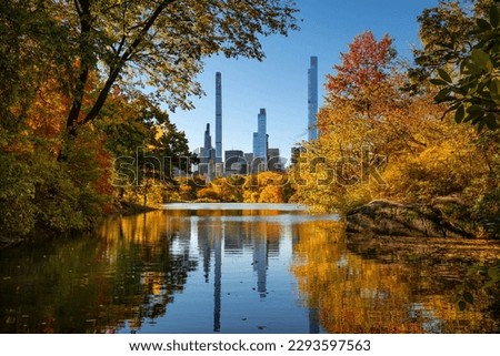 Central Park in Autumn with view of Billionaires' Row skyscrapers from The Lake. Manhattan, New York City