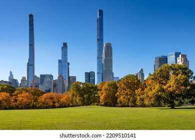 Central Park In Fall With Billionaires Row Skyscrapers From Sheep Meadow. Midtown Manhattan, New York City