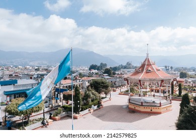 Central park in San Marcos Guatemala - Guatemalan flag waving in the central square with old kiosk - picturesque Latin American park - Powered by Shutterstock