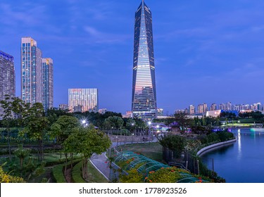 Central Park, Songdo, Yeonsu-gu, Incheon, South Korea - August 31, 2019: Night View Of Walkway And Trees With The Background Of Northeast Asia Trade Tower
