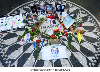 Central Park,NYC,USA.Oct 9,2020. Friends and fans celebrated John Lennon's 80th birthday in Strawberry Fields, Central Park. Many flowers and photos were put on the "Imagine" mosaic.