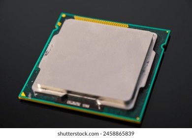 Central processing unit (CPU) resting on a dark surface. Computing chip on an old motherboard. Old electronics close-up. Electronic background. Selective focus - Powered by Shutterstock - Get 15% off with code: PIKWIZARD15