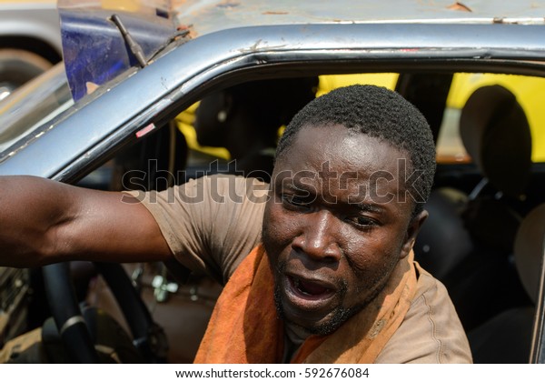 CENTRAL REGION, GHANA - Jan 17, 2017:\
Unidentified Ghanaian man drives a car in local village. People of\
Ghana suffer  poverty due to the bad\
economy