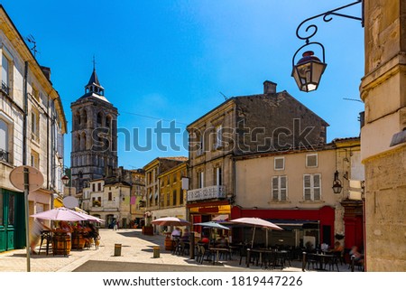 Central street of French town of Cognac overlooking bell tower of Saint Leger Church