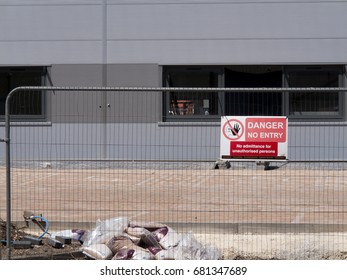 Central Way, Feltham, Middlesex, England - July 17, 2017: Danger No Entry Sign Mounted On Security Fencing, New Commercial Warehouse And Office Development