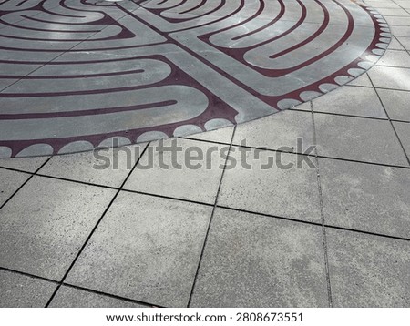 A centuries-old labrinth pattern decorates this outdoor courtyard in uptown Charlotte. Detail. NC 2026