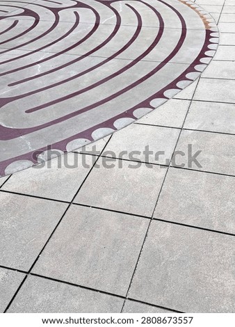A centuries-old labrinth pattern decorates this outdoor courtyard in uptown Charlotte. Detail. NC 2026