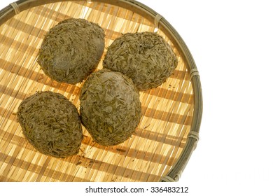 Century eggs in a bamboo tray with glow light from the white background.  Chinese delicacy of preserved egg in a mixture of clay, ash, salt, quicklime, and rice hulls for several weeks to months. - Powered by Shutterstock