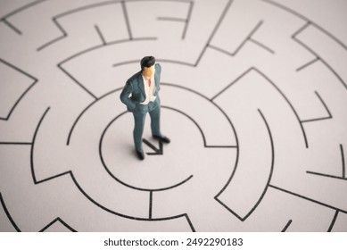 CEO businessman stand up at center of complex maze background and contemplation for best solution. Business management and planning, business strategy, problem solution, leadership concept. - Powered by Shutterstock