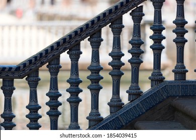  Ceramic balustrade in blue and white  with blurred architectural background in the Spain Square of Seville, Andalusia, Spain, Europe. 