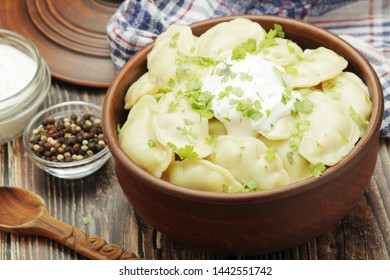 A ceramic bowl with freshly cooked Russian vareniki with mashed potato